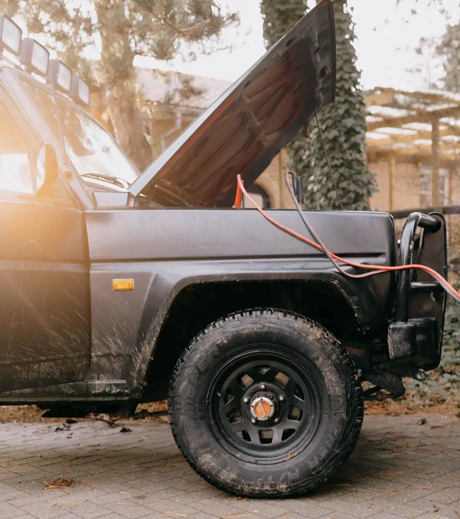 Jumper cables running to a truck with its hood up (representative photo)