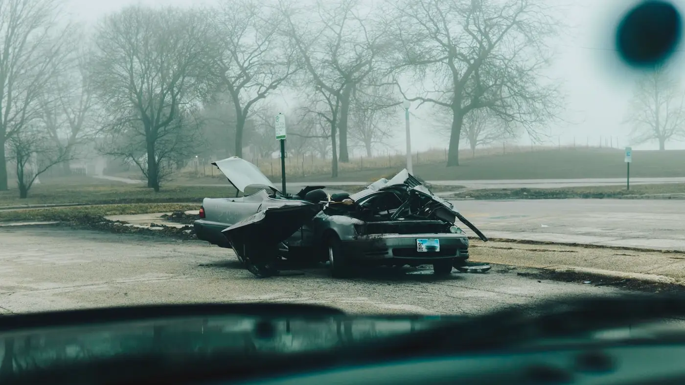 A wrecked car at the side of a road on a foggy morning (representative photo)